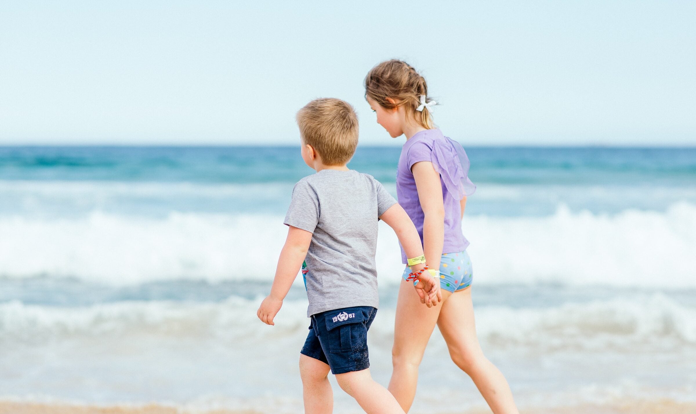 Siblings holding hands on a travel vacation
